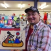 Gull Bay artist Kevin Belmore with his animal protest painting that features a group of animals leaving in a canoe over man’s destruction of the environment.  Photo by Rick Garrick